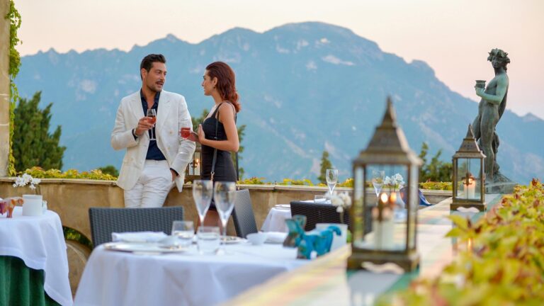 A couple with drinks beside a laid table on the terrace, Villa Cimbrone