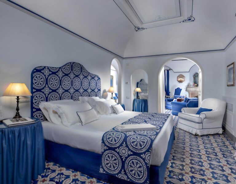 Suite with a vaulted ceiling and a blue and white bed, Villa Cimbrone