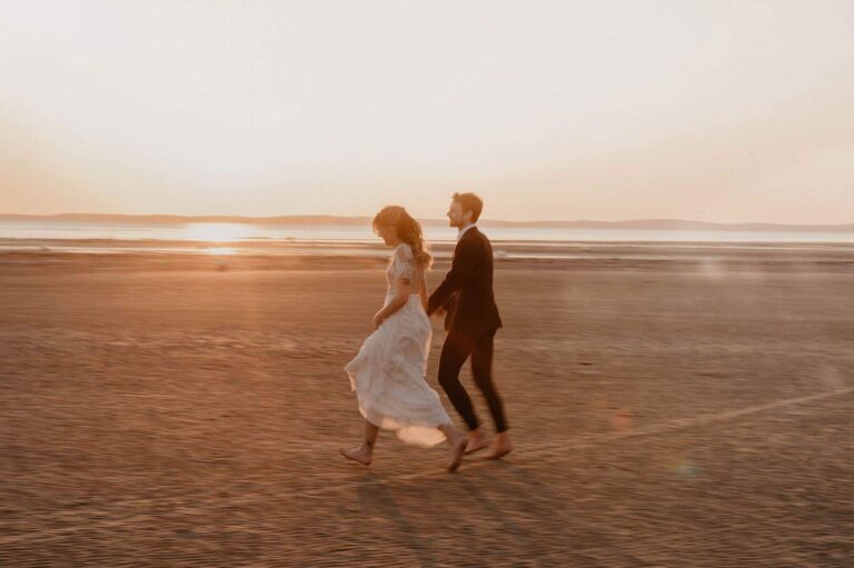A couple walking on the beach at sunset, Villa la Tosca