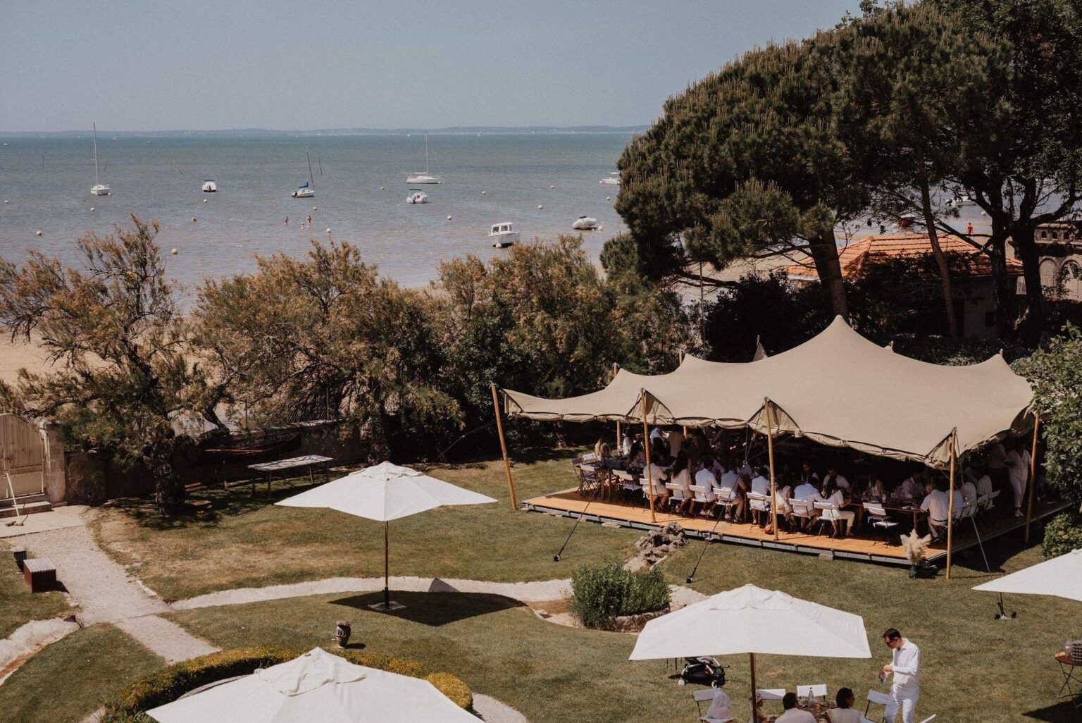 A tent on the lawn above the bay, set with a long table