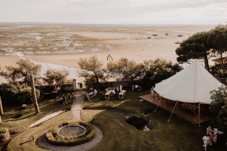 The lawn, fire pit and tent beside the beach seen from above, Villa la Tosca