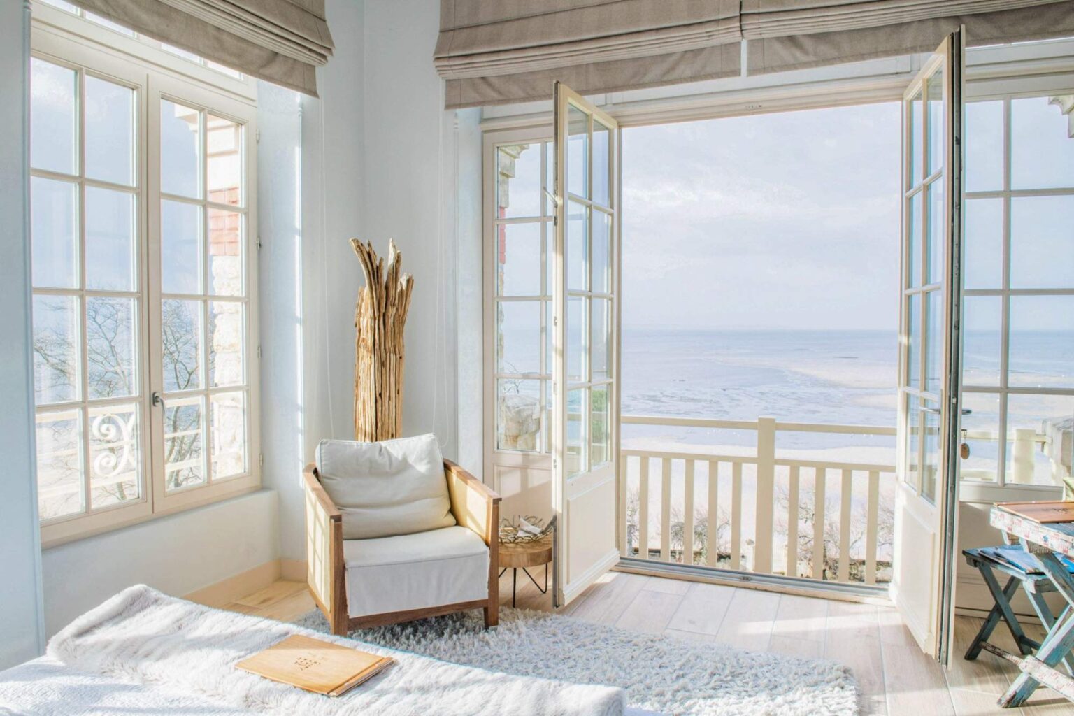 A bedroom with a balcony facing the bay