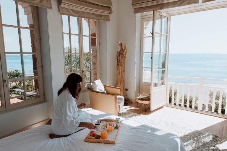 Breakfast on the bed beside open balcony doors, Villa la Tosca