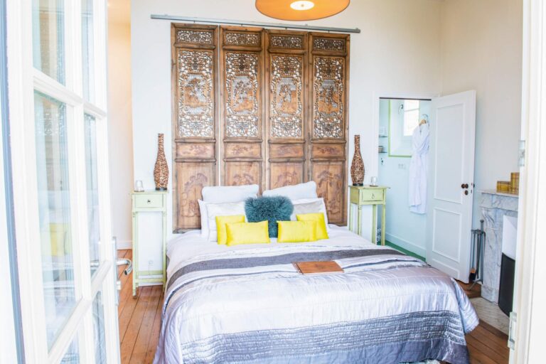 Bedroom with a carved wooden headboard, Villa la Tosca