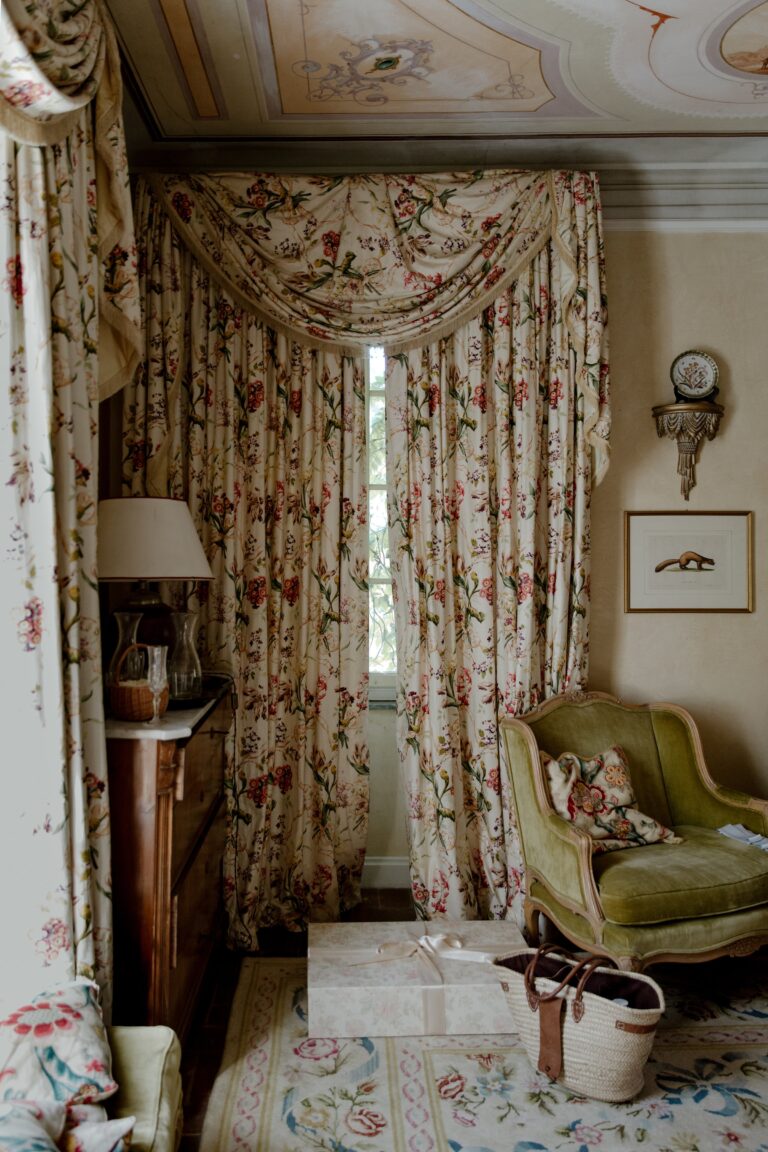 A sitting room with floral curtains and antique armchair, Villa Michaela