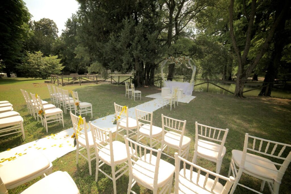 A ceremony set under the trees in the romantic park, Villa Mosconi Bertani