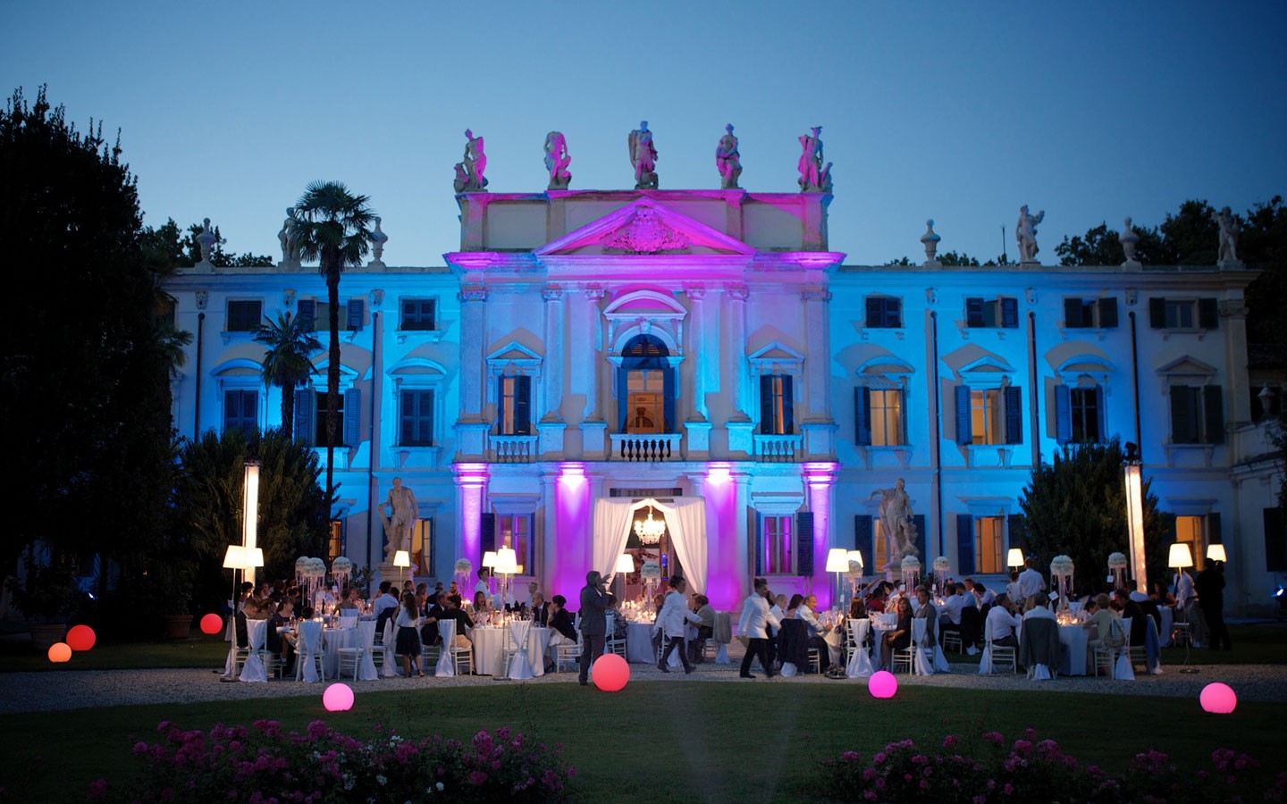 The villa facade lit in blue and pink for an evening event, Villa Mosconi Bertani