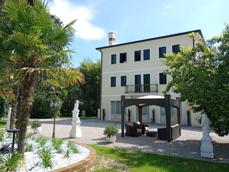 The Venetian villa in its park, a gazebo, statues and potted greenery on the gravel forecourt beneath the facade, Villa Pace Park Hotel Bolognese