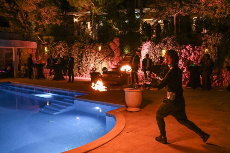 A fire performance beside the pool at night, Villa Ponta Melagrana