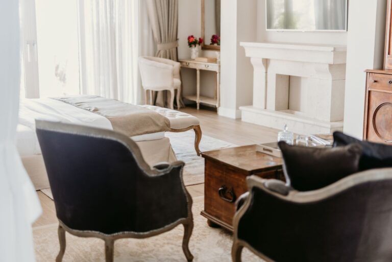 A sitting area with armchairs and a fireplace, Villa Ponta Melagrana