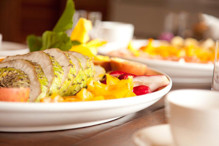 A plate of fresh fruit and breakfast dishes on the table, Villa Susanna St Lucia