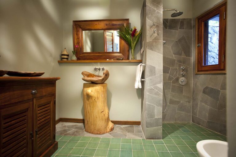 A bathroom with a teak-framed mirror, stone-clad shower and green tiles, Villa Susanna St Lucia