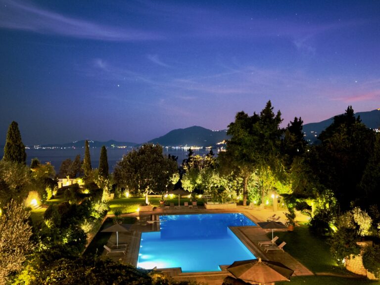 Pool and gardens lit at night, Villa Sylva