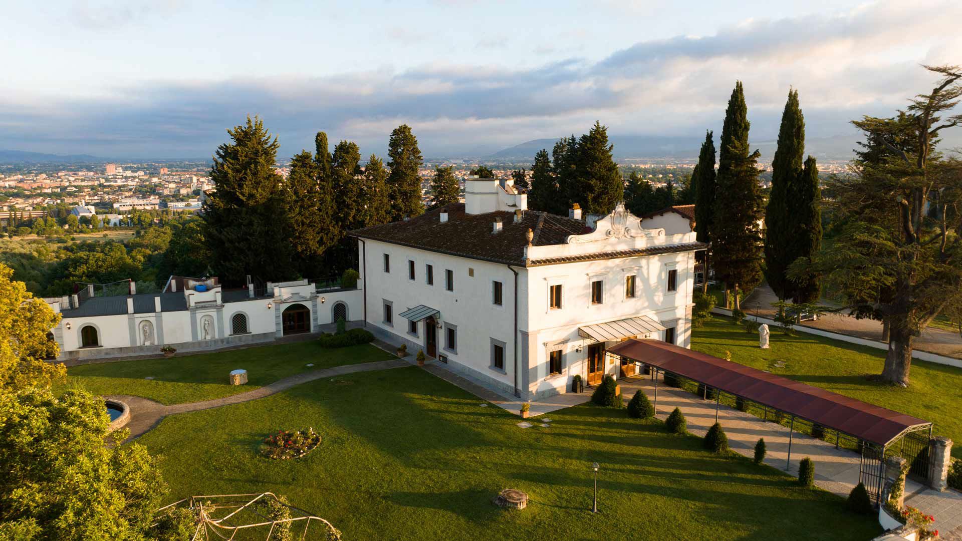 The villa and its lawn seen from the gardens, Villa Tolomei Hotel