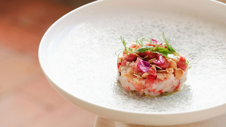 A plated starter with edible flowers, Villa Tolomei Hotel