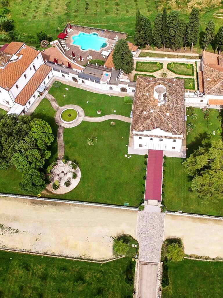 The formal gardens and the entrance avenue from above, Villa Tolomei Hotel