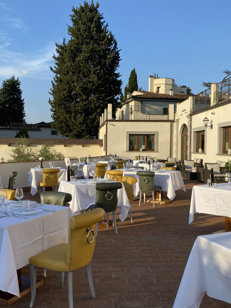 Tables on the panoramic terrace, Villa Tolomei Hotel