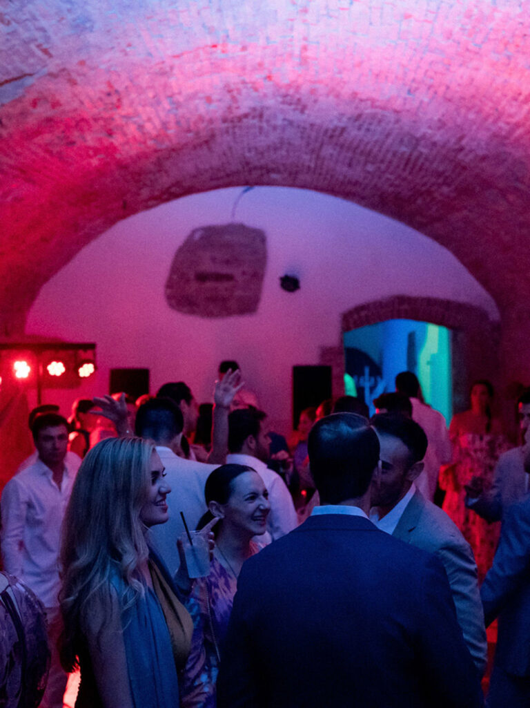 An evening party under stone vaults, Villa Tolomei Hotel