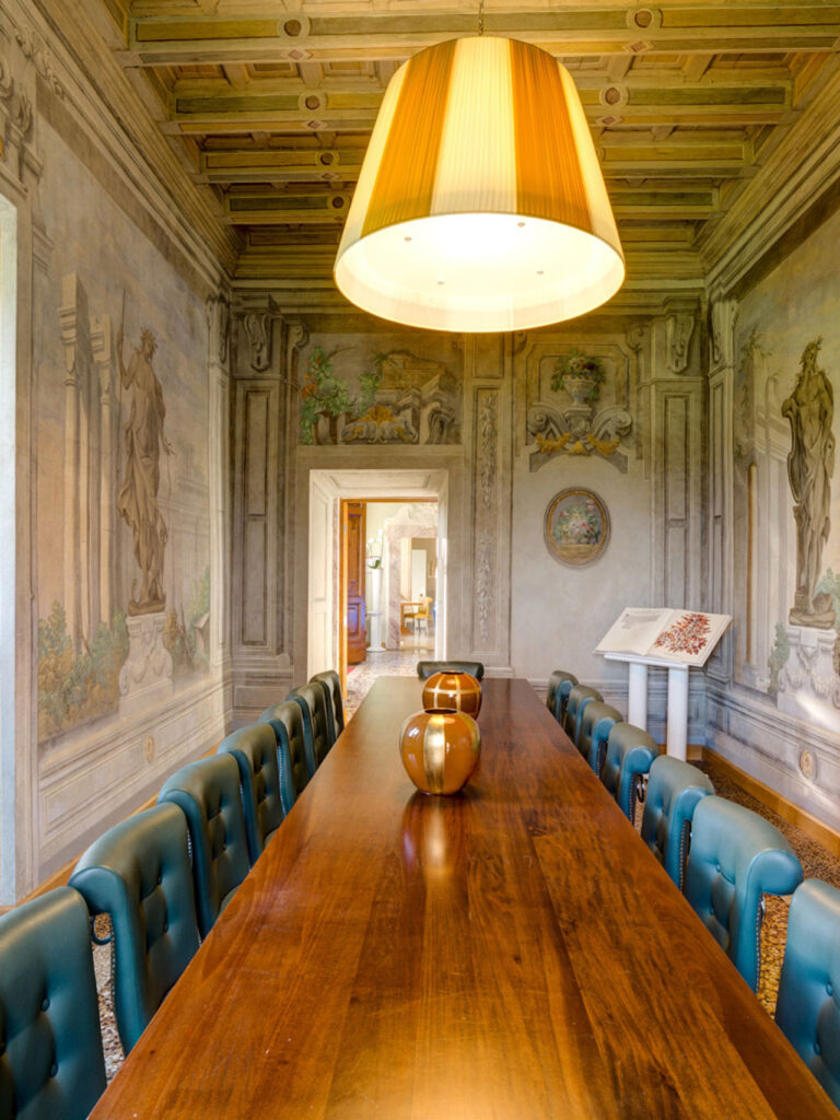 The frescoed room set with a long table, Villa Tolomei Hotel