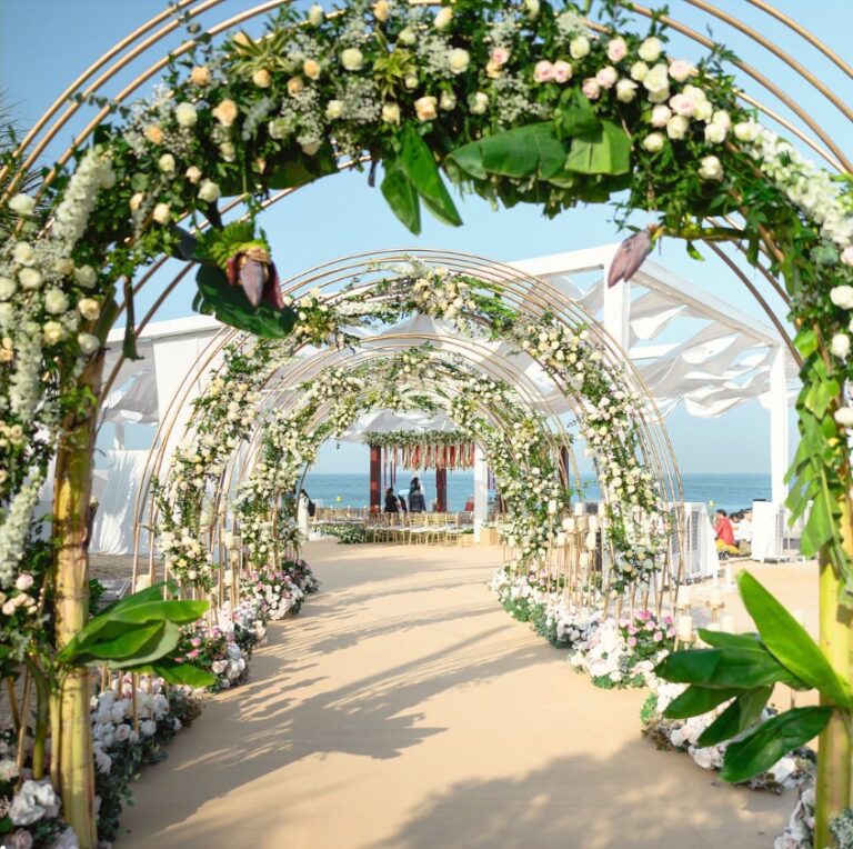 Tunnel of floral arches leading to a mandap on the beach, Vivaah Weddings