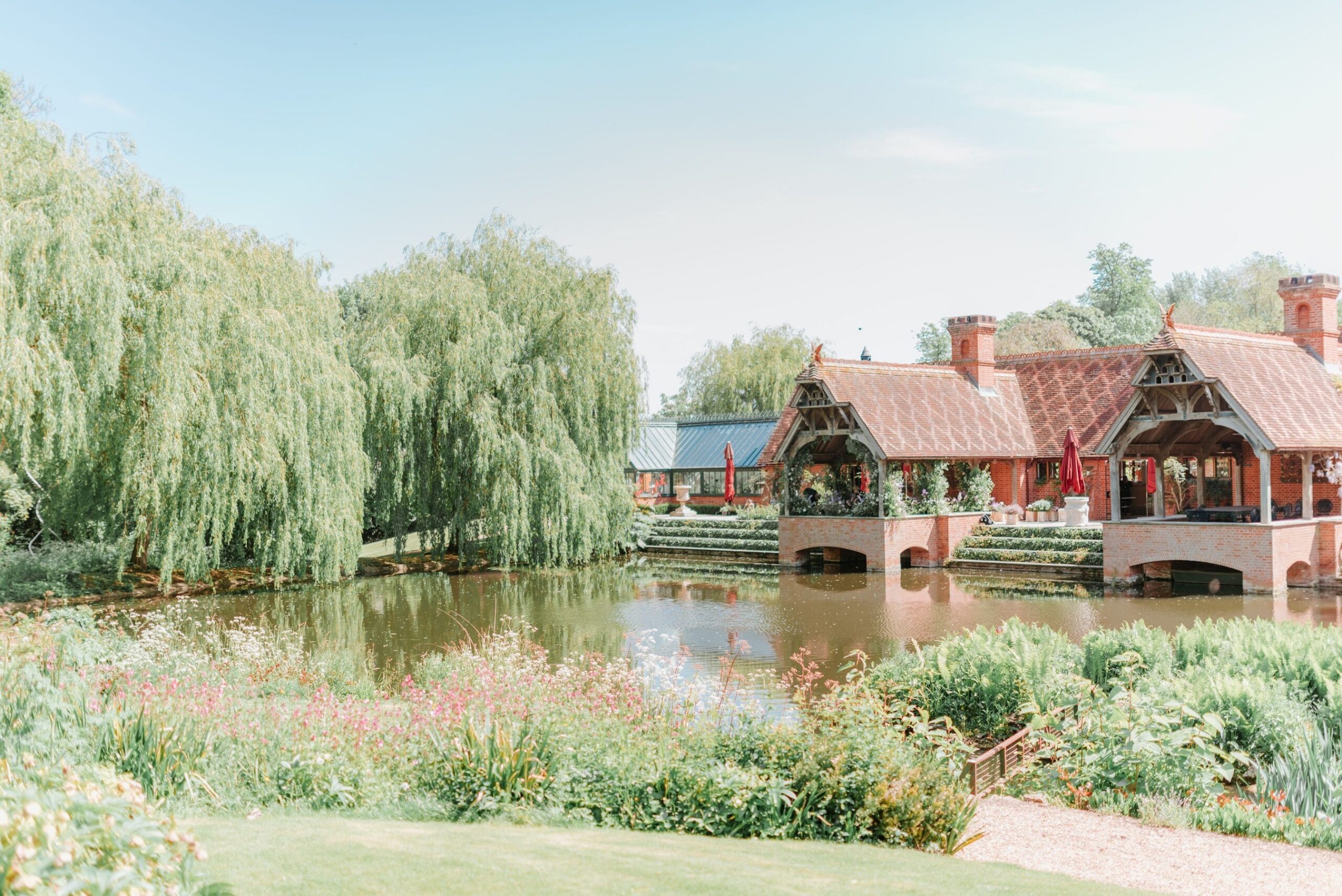 The Dairy, reflected in its lake among the willows, Waddesdon Manor