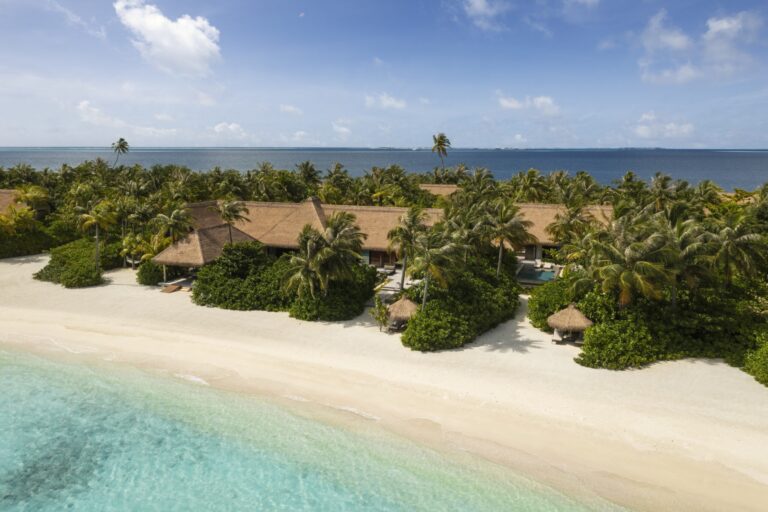 Beach villas set among palms behind the sand, Waldorf Astoria Maldives Ithaafushi