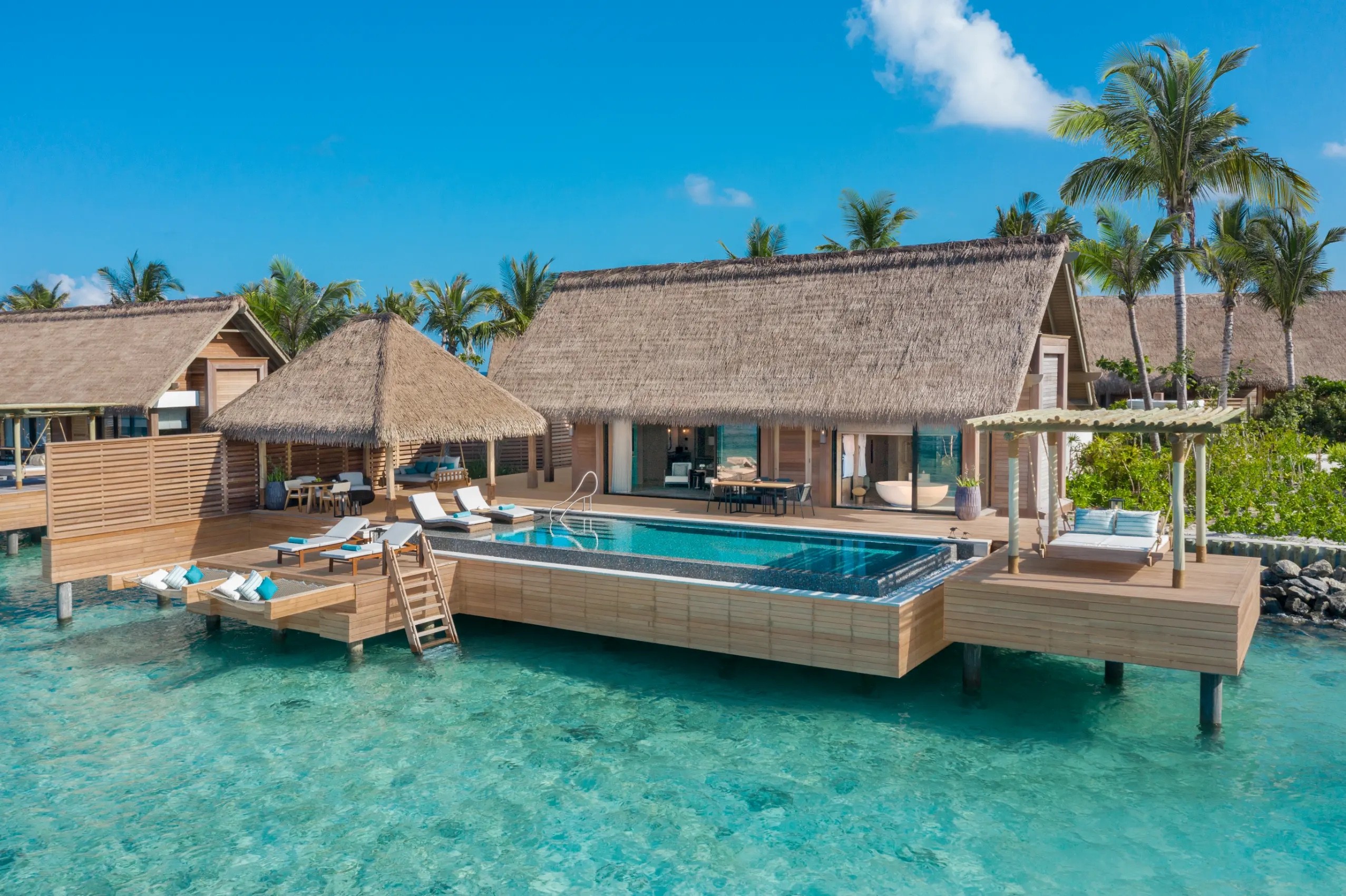 An overwater villa with a pool and a sun deck, Waldorf Astoria Maldives Ithaafushi