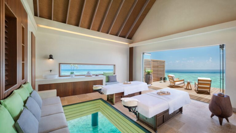 A treatment suite with a glass floor panel over the lagoon, Waldorf Astoria Maldives Ithaafushi