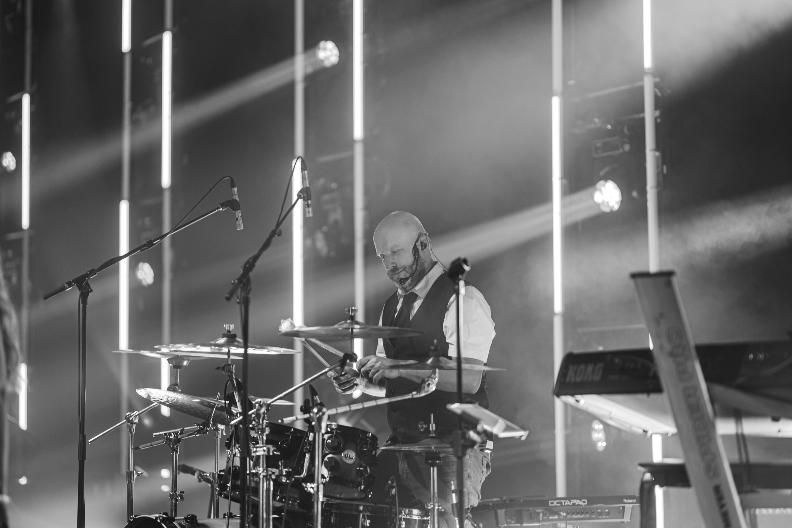 The drummer under stage lighting, in black and white, Waterfront