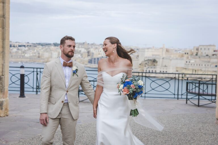 Couple walking along a balcony above the Grand Harbour, Wed In Malta