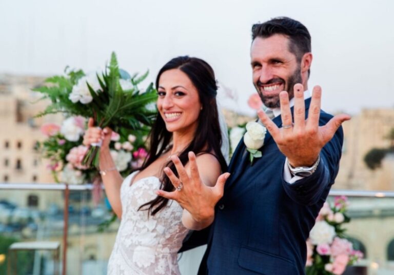 Newlyweds showing their rings with a bouquet on a rooftop terrace, Wed In Malta
