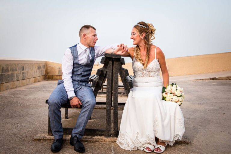 Couple seated on a bench on the bastion walls, Wed In Malta