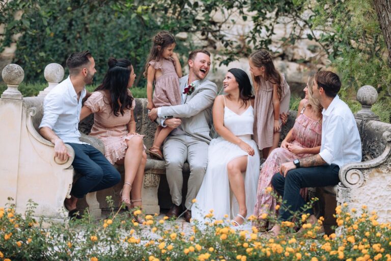 Couple with family on a garden bench among flowers, Wed In Malta