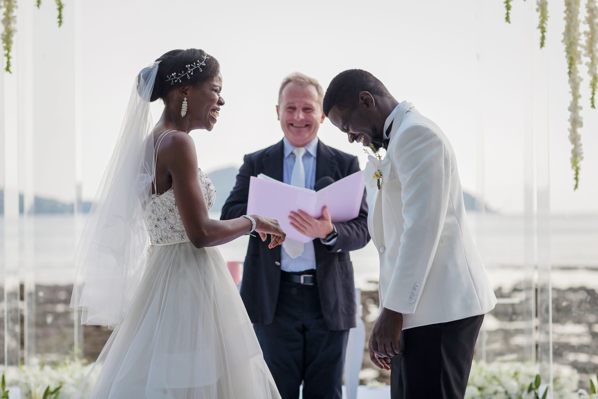 Ring exchange at a seafront ceremony at Thavorn Beach Village, Phuket, Wedding Celebrant Phuket - Paul Cunliffe