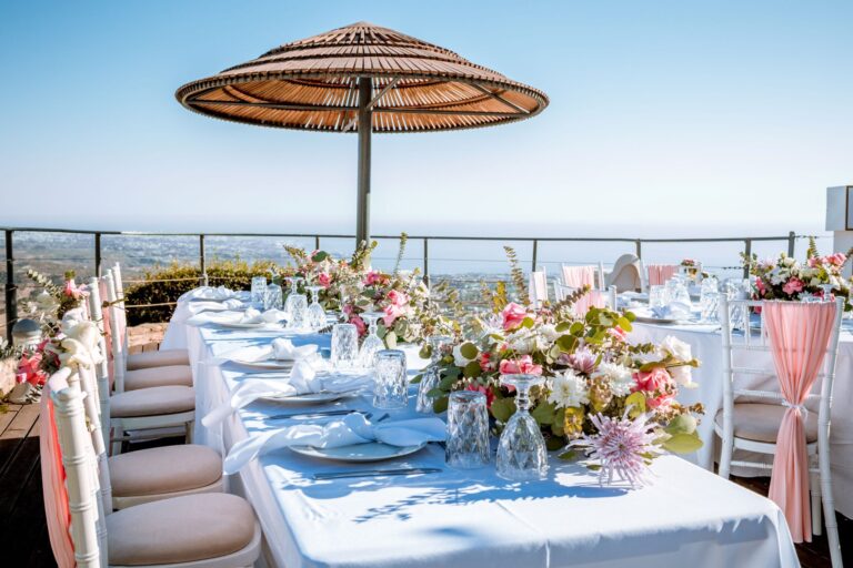 A long dinner table with floral centrepieces on the Umbrella Deck, Wedding Cyprus Villas
