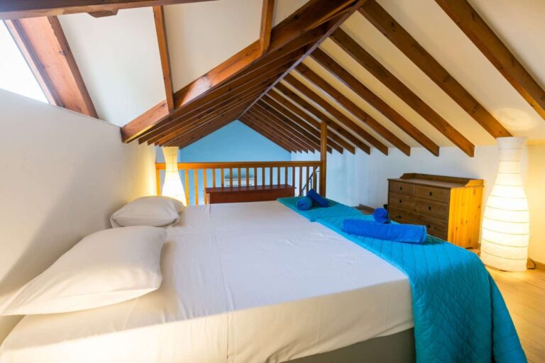 A bedroom under the timber roof at Villa Panorama, Wedding Cyprus Villas