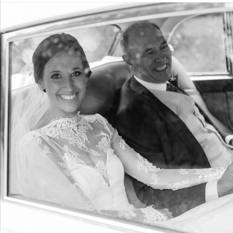 Black and white, a bride and her father share a smile in a vintage wedding car, Wedding Hair And Makeup By Lisa