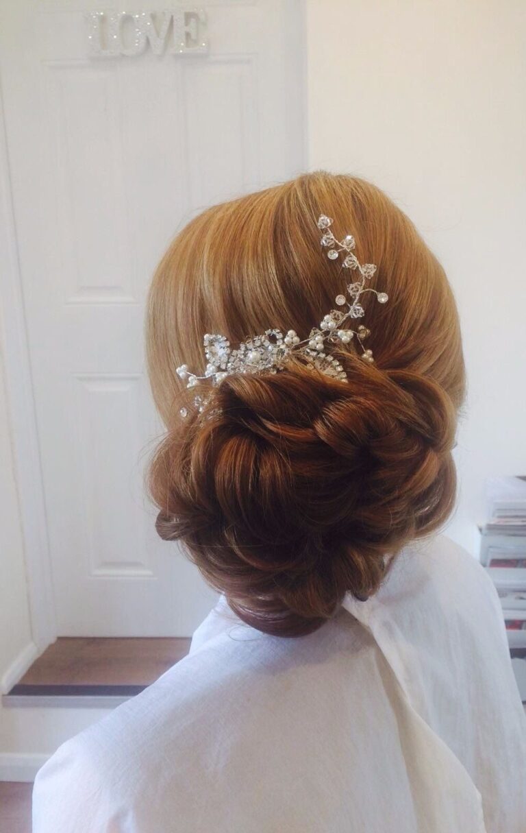An updo finished with a crystal hair vine, a LOVE sign on the door behind, Wedding Hair And Makeup By Lisa