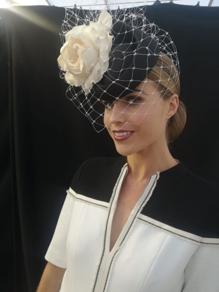 A black birdcage-veil fascinator finished with a silk rose, a race-day look, Wedding Hair And Makeup By Lisa