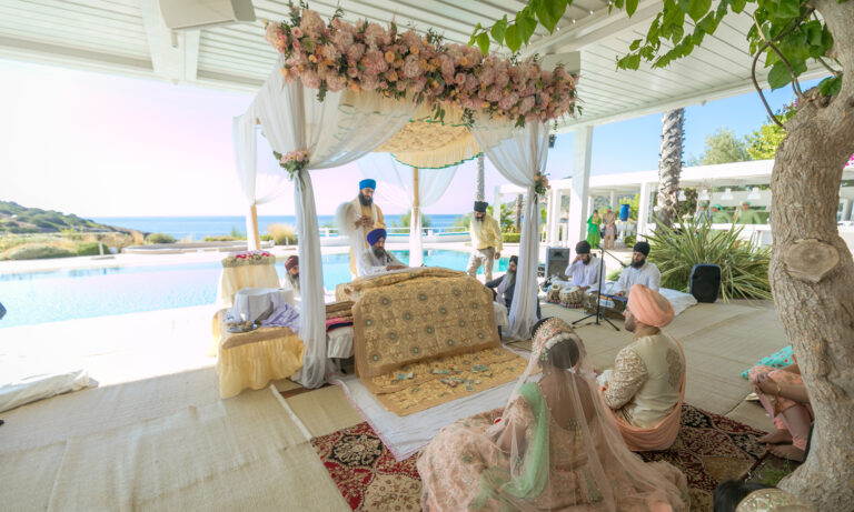 A floral canopy and ceremony seating on a terrace above the sea, Wedding in Greece