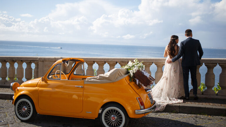 Couple on a terrace beside the Fiat 500, Sorrento Coast, Wedding In Yellow Vintage