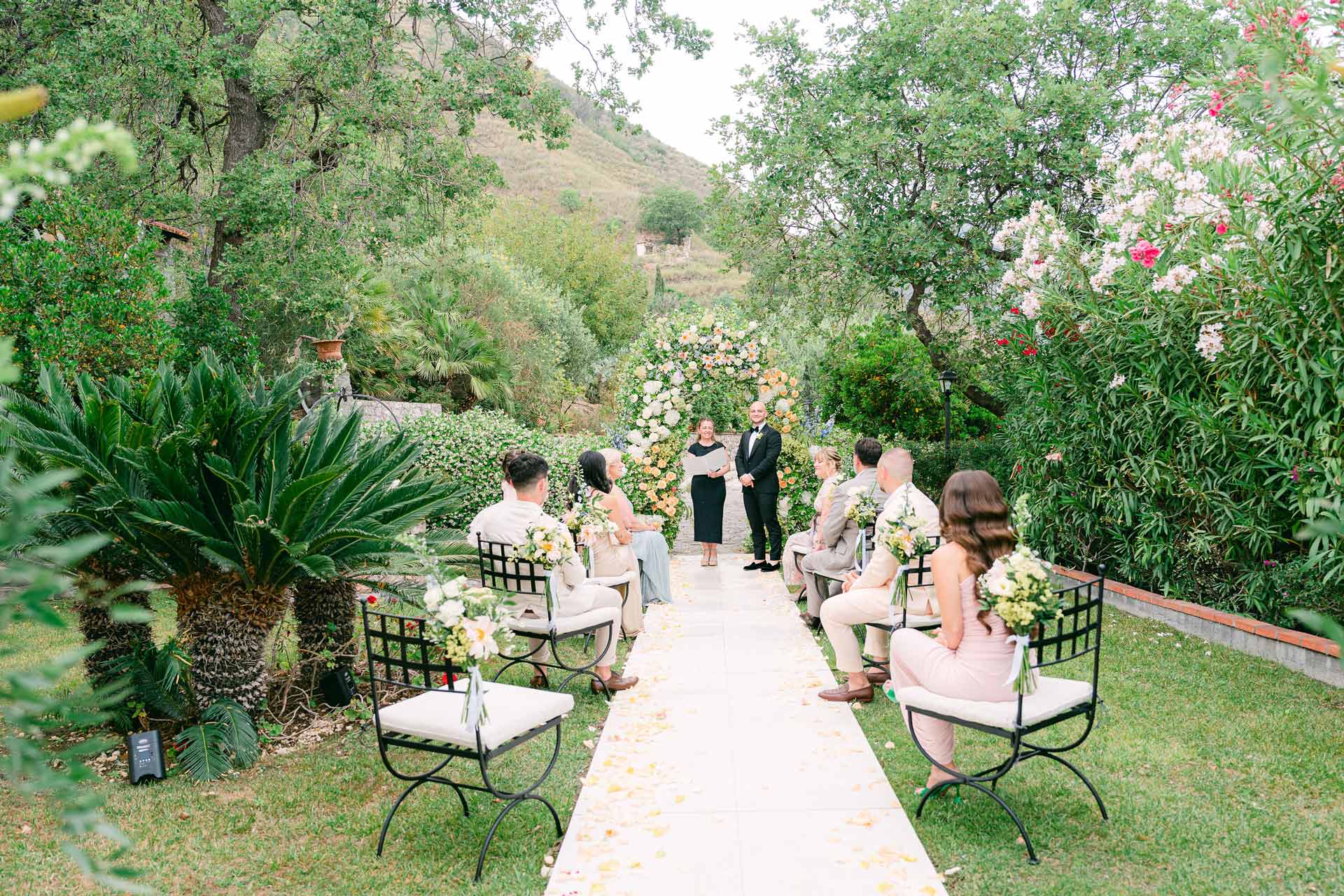 Garden ceremony with a flower arch, palms and an aisle of petals, Sicily, Wedding Sicily