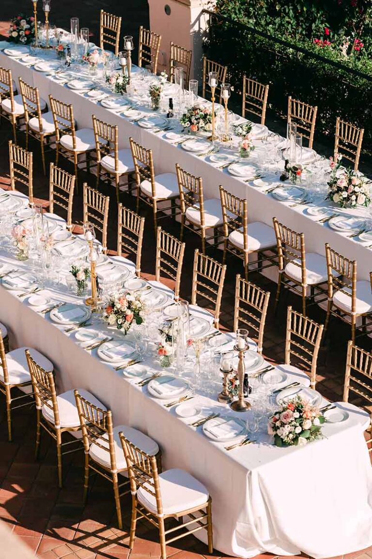 Aerial view of long tables with gold chairs on a terrace, Wedding Sicily