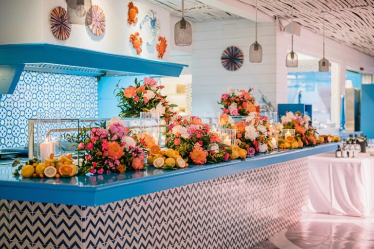 A bar dressed with orange and pink flowers and citrus under a blue tiled hood, Capri, Weddings Amalfi