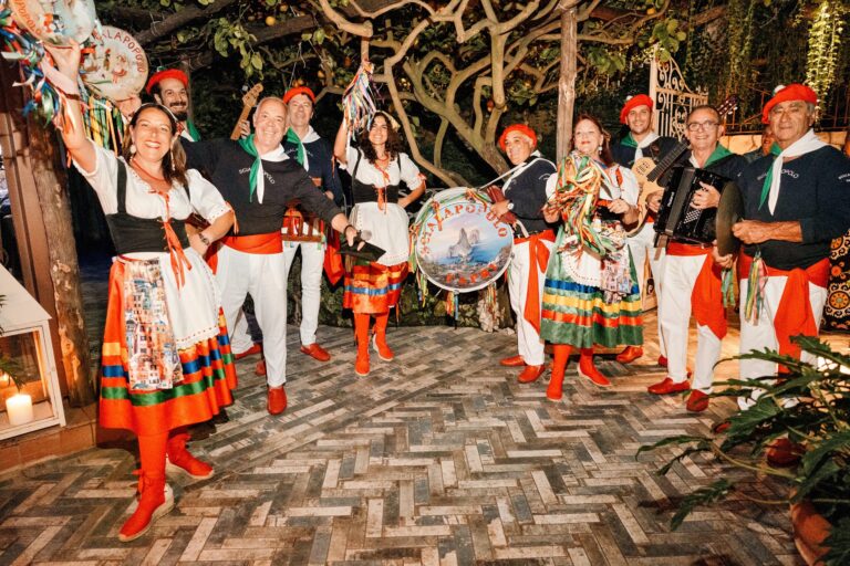 A folk troupe in traditional costume with tambourines and an accordion on a herringbone terrace, Capri, Weddings Amalfi