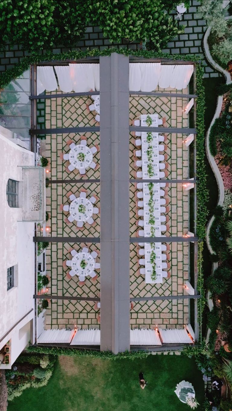 Three long tables in a walled, tiled courtyard, photographed from directly overhead, Weddings Amalfi