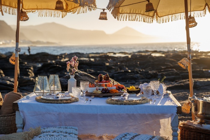 A table set on a terrace above the coast, Weddings and Events by Natalia Ortiz
