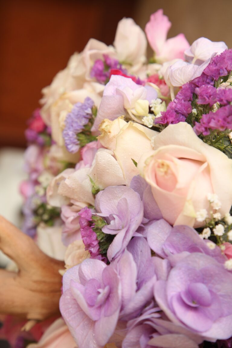A bridal bouquet of pale roses, lilac hydrangea and statice, WEM Eventi