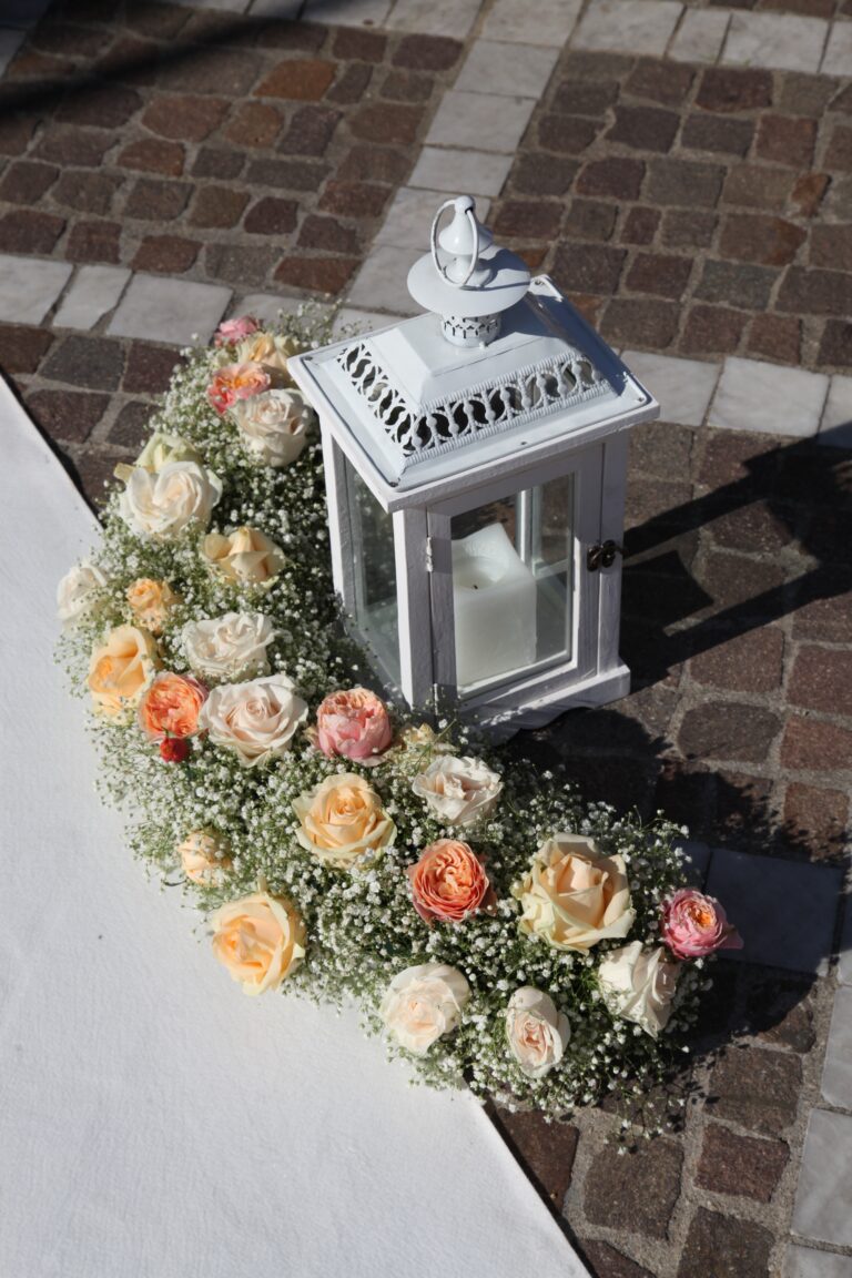 A white lantern and a crescent of peach roses and gypsophila on the church steps, WEM Eventi