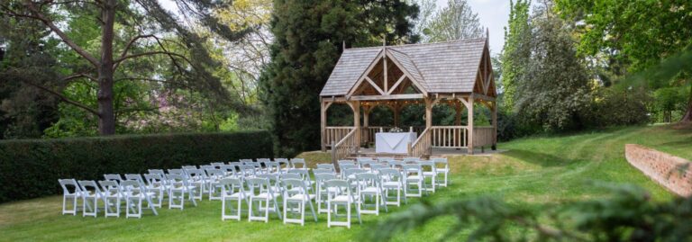Chairs set before the garden pavilion for an outdoor ceremony, West Lodge Park